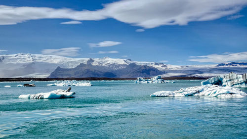 Scenic view of glacier lagoon against sky during summer