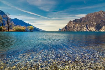 Scenic view of sea and mountains against sky