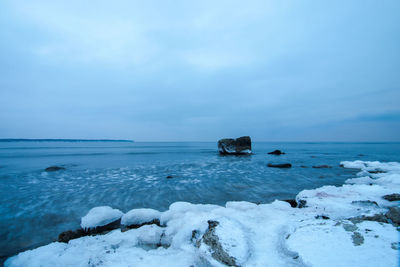 Scenic view of sea against sky during winter