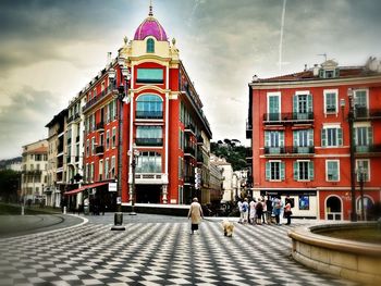 Buildings against cloudy sky