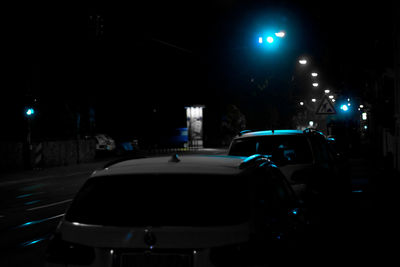 Cars on illuminated street light