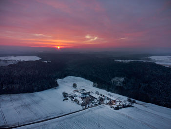 High angle view of snow against sky during sunset