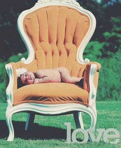 Low section of man sitting on chair at field