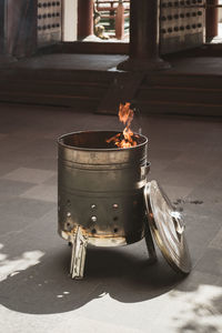 Metallic fire pit burning with flames