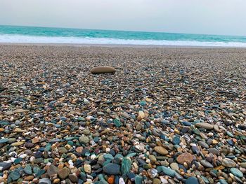 Pebbles on beach against sky