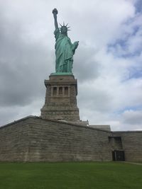 Low angle view of statue against cloudy sky