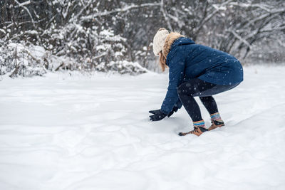 Side view of woman on snow field