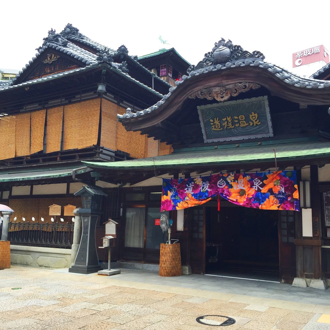 building exterior, architecture, built structure, text, religion, clear sky, spirituality, place of worship, temple - building, tradition, non-western script, culture, cultures, outdoors, entrance, day, low angle view, art and craft, facade