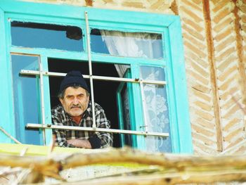 Portrait of man in window