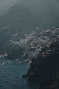 High angle view of sea and buildings in city