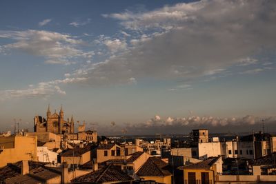 Cityscape against cloudy sky