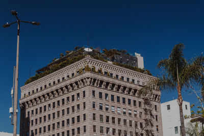 Low angle view of buildings against blue sky