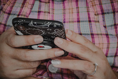 Close-up of woman hand using mobile phone