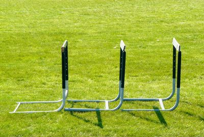 Empty bench on grassy field