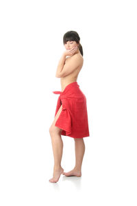 Portrait of woman standing against white background