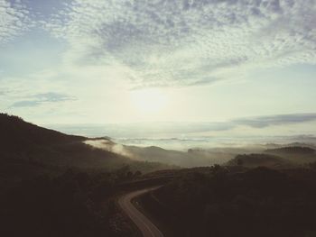 Road by landscape against sky