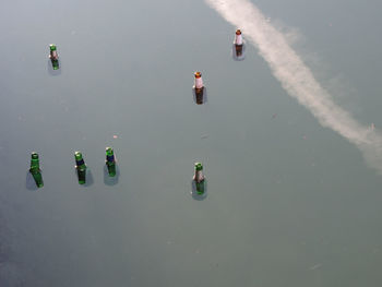 High angle view of people floating on lake