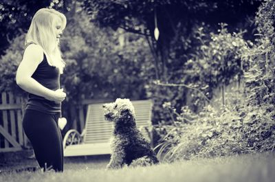 Woman with welsh terrier in park