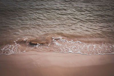 High angle view of waves rushing towards shore