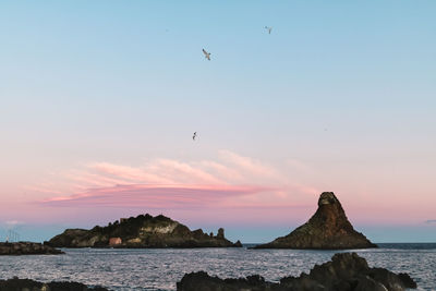 Low angle view of sea against sky during sunset