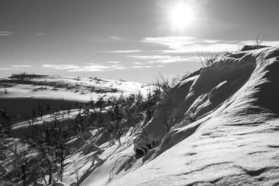 Scenic view of snow covered landscape against sky