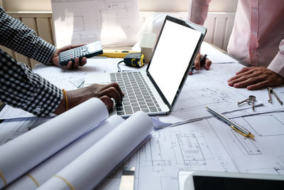 Low angle view of people working on table