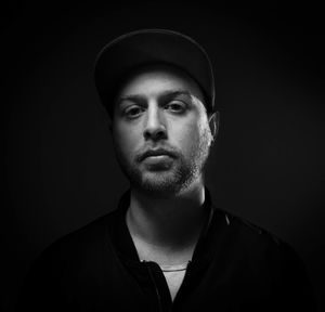 Portrait of young man against black background