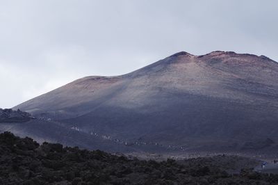 Scenic view of volcanic mountain against sky