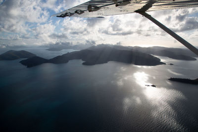 Aerial view of sea and mountains against sky