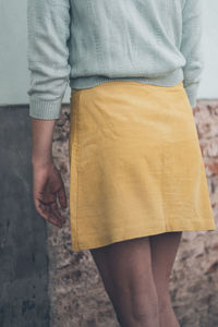 Midsection of woman standing at home