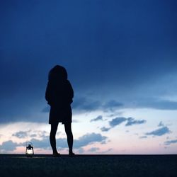 Woman standing by sea