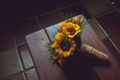 High angle view of bouquet on wooden table