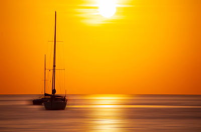 Scenic view of sea against orange sky