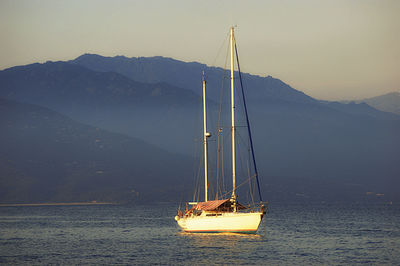 Sailboat sailing on sea against sky