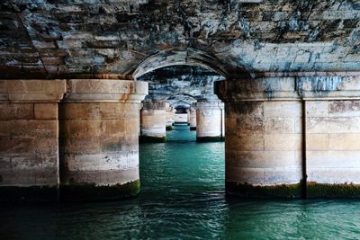 Row of bridge columns over river