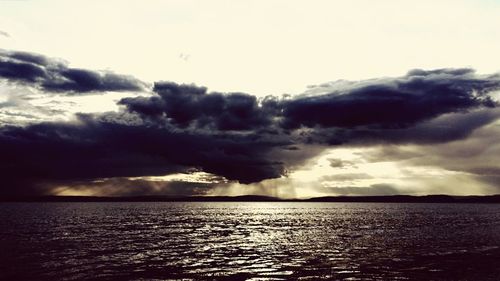 Scenic view of sea against cloudy sky