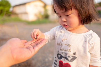 Close-up of cute baby girl with hands