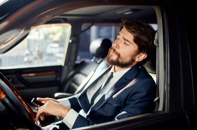 Businessman relaxing in car