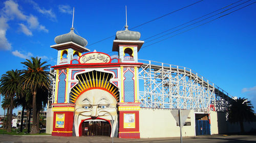 Low angle view of amusement park against sky