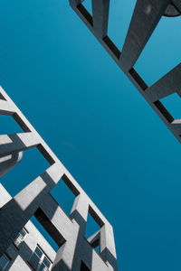 Low angle view of swimming pool against clear blue sky