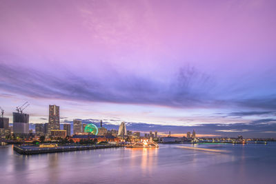 Panorama pink sunset view of the cosmo clock 21 big wheel, landmark tower and pacifico yokohama.