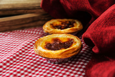 Close-up of tarts on checked tablecloth