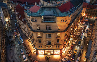 High angle view of illuminated street amidst buildings in city