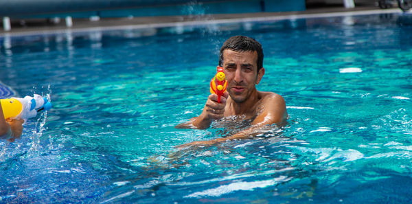 Young man swimming in pool