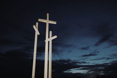 Low angle view of crosses against sky at night