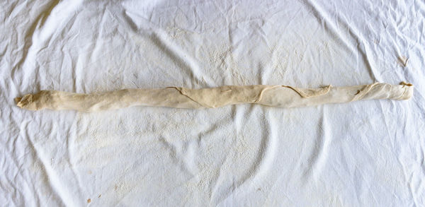 High angle view of dough on white textile