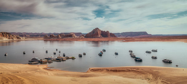 Panorama of boats on lake powell, arizona with low water level.