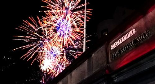 Low angle view of firework display at night