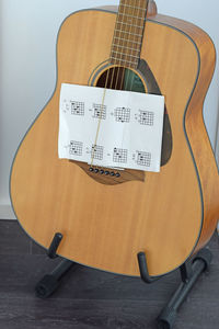 High angle view of guitar on hardwood floor