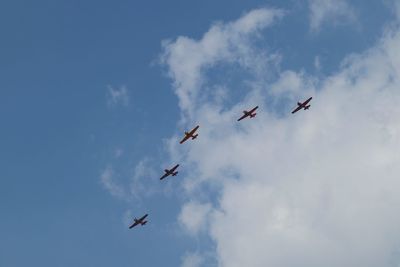 Low angle view of airshow against sky